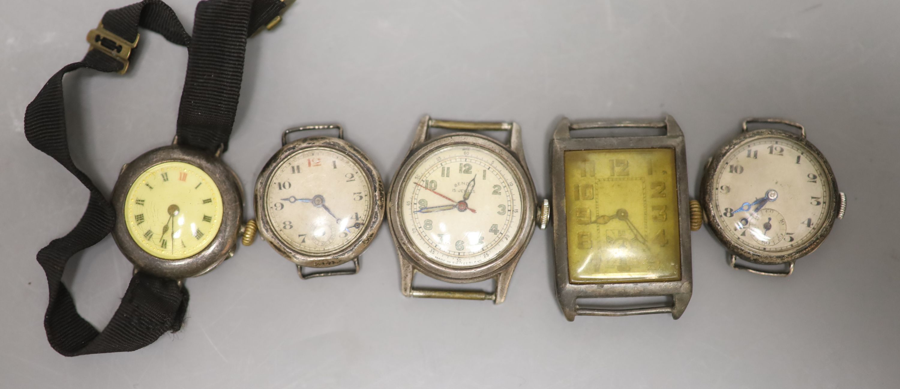 Five assorted wrist watches including four silver(a.f.).